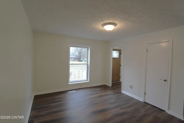 a bathroom with a granite countertop sink toilet a mirror and shower