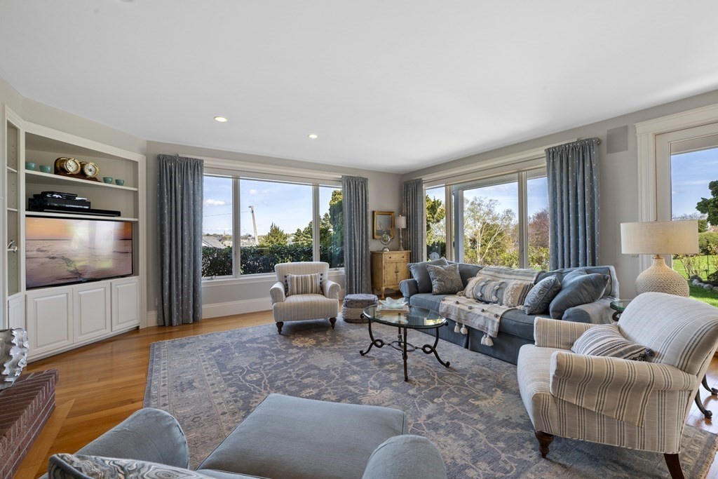 25 Foster Street Marblehead, MA 01945 - Photo 18 of 42 a living room with furniture floor to ceiling window and a flat screen tv