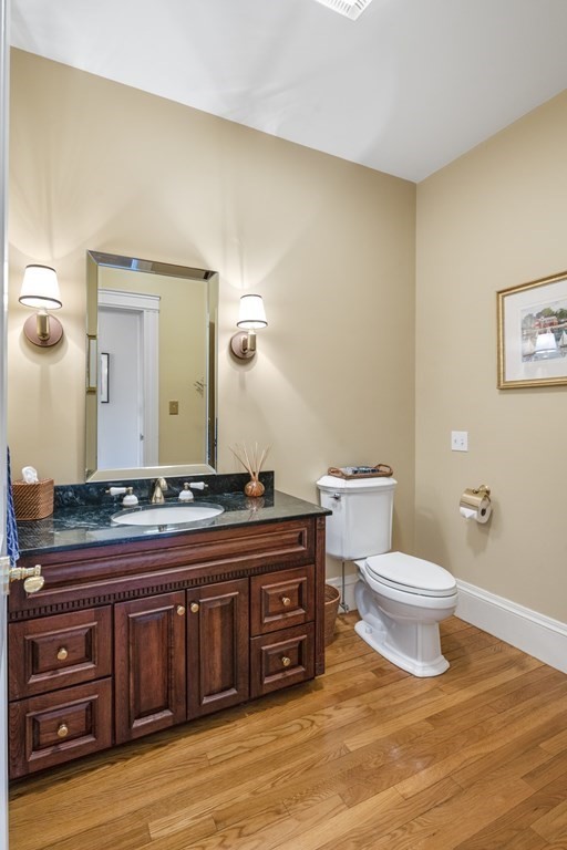 25 Foster Street Marblehead, MA 01945 - Photo 19 of 42 a bathroom with a toilet a sink and a mirror