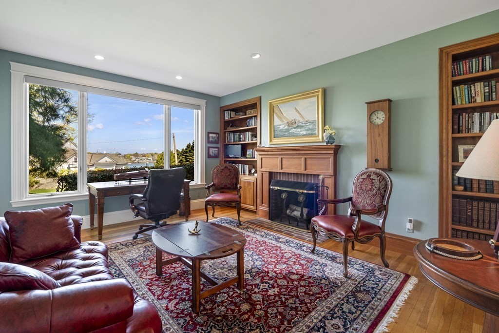 25 Foster Street Marblehead, MA 01945 - Photo 20 of 42 a living room with furniture a rug and a fireplace