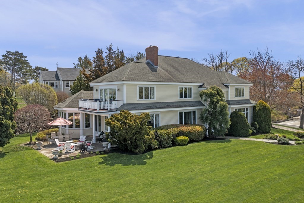 25 Foster Street Marblehead, MA 01945 - Photo 2 of 42 a front view of a house with garden and trees