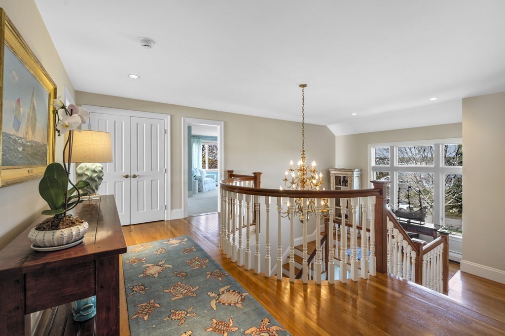 25 Foster Street Marblehead, MA 01945 - Photo 23 of 42 a view of a dining room and livingroom with furniture wooden floor a chandelier