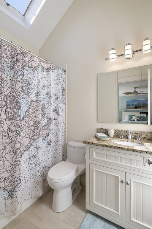 25 Foster Street Marblehead, MA 01945 - Photo 25 of 42 a bathroom with a granite countertop toilet a sink and a mirror