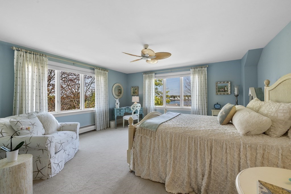 25 Foster Street Marblehead, MA 01945 - Photo 26 of 42 a bedroom with a large bed couch and windows