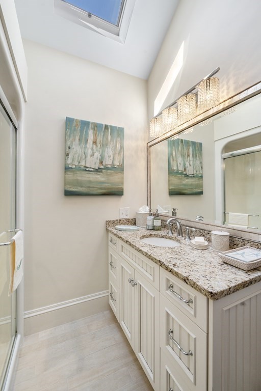 25 Foster Street Marblehead, MA 01945 - Photo 28 of 42 a bathroom with a granite countertop sink and a mirror