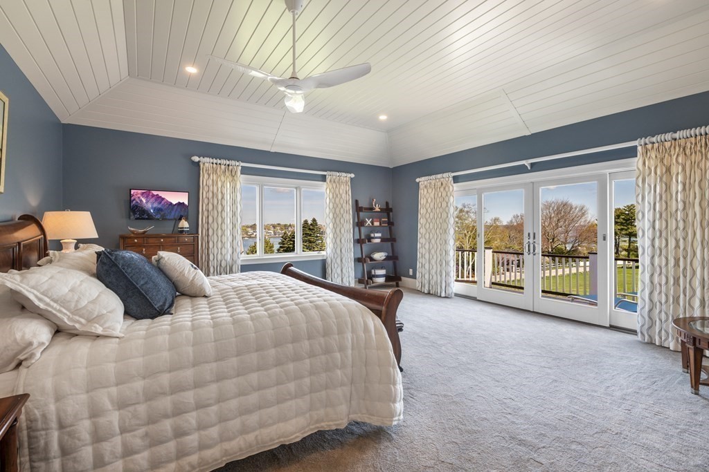 25 Foster Street Marblehead, MA 01945 - Photo 32 of 42 a bedroom with a large bed and a large window