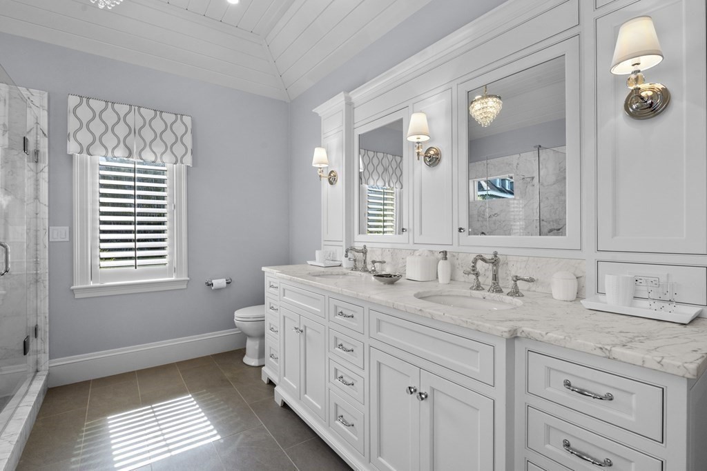 25 Foster Street Marblehead, MA 01945 - Photo 36 of 42 a bathroom with a granite countertop sink mirror and a window
