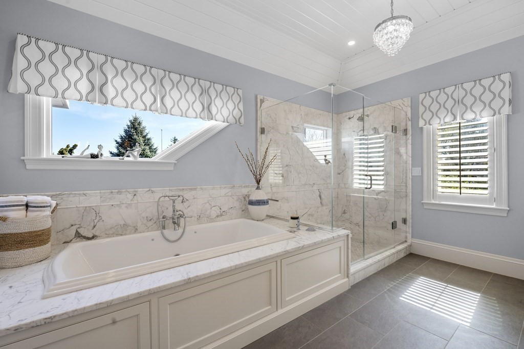 25 Foster Street Marblehead, MA 01945 - Photo 37 of 42 a spacious bathroom with a tub sink and mirror