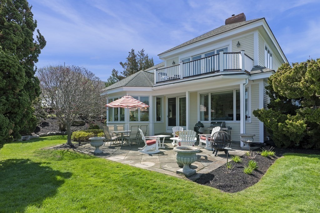 25 Foster Street Marblehead, MA 01945 - Photo 5 of 42 a front view of house with yard and outdoor seating