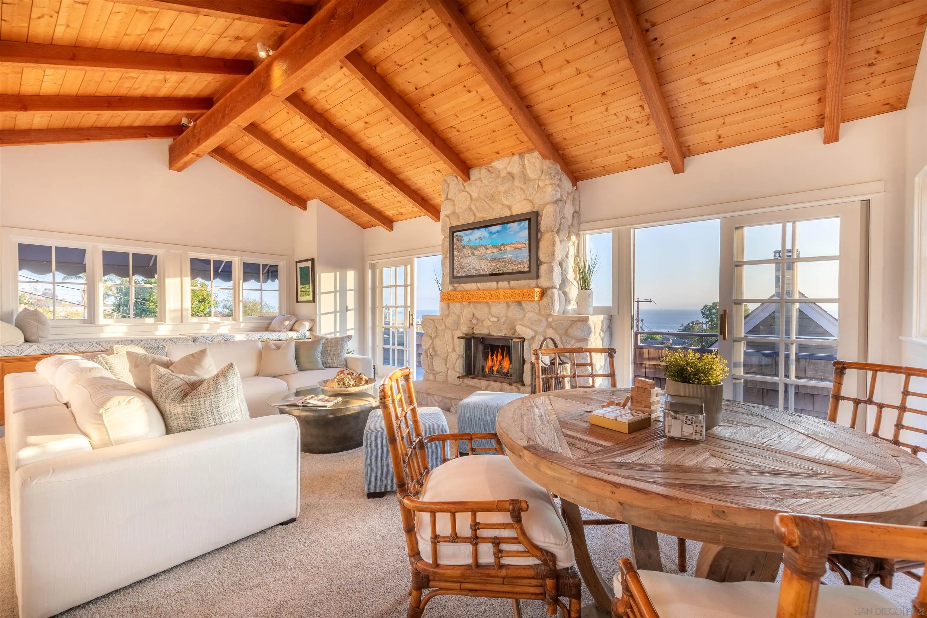 a view of a dining room with furniture large windows and wooden floor