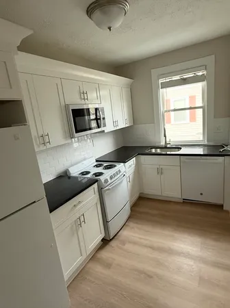 a kitchen with stainless steel appliances granite countertop a sink and a stove top oven