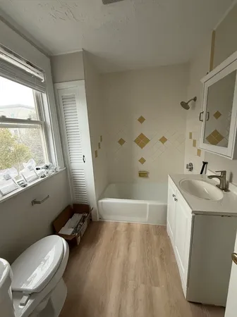 a bathroom with a granite countertop sink toilet and shower
