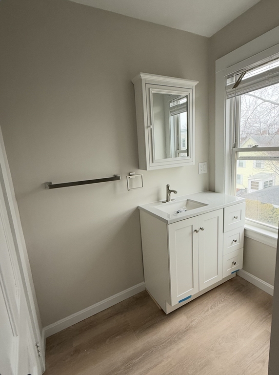 98 Paradise Road, Unit 1 Swampscott, MA 01907 - Photo 8 of 10 a bathroom with a granite countertop sink and a mirror