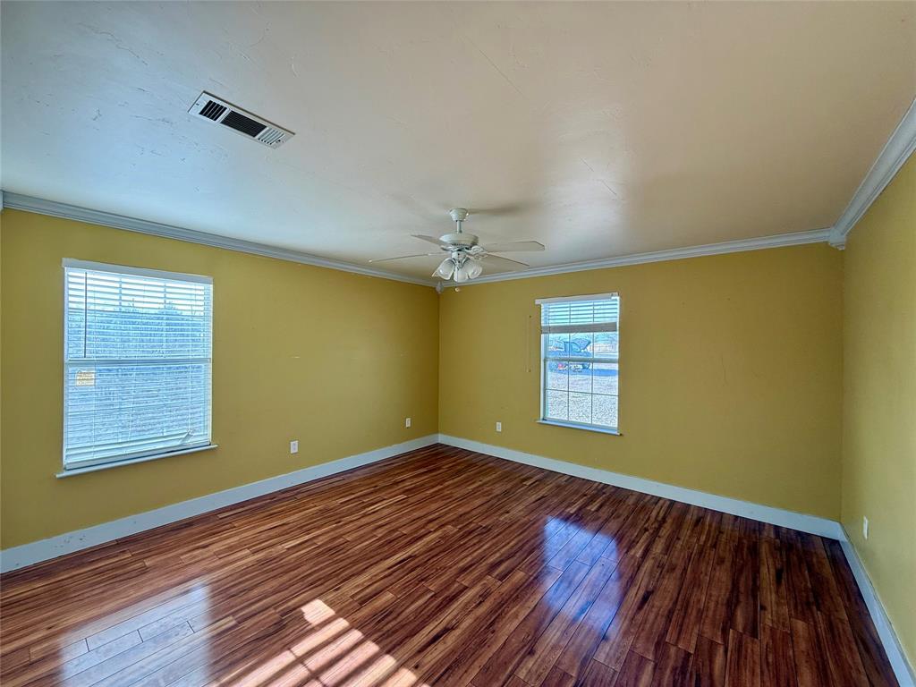 487 County Road 2622 Decatur, TX 76234 - Photo 13 of 20 a view of an empty room with wooden floor and a window