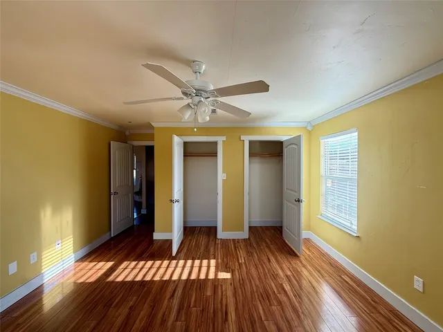 a view of a room with wooden floor and staircase