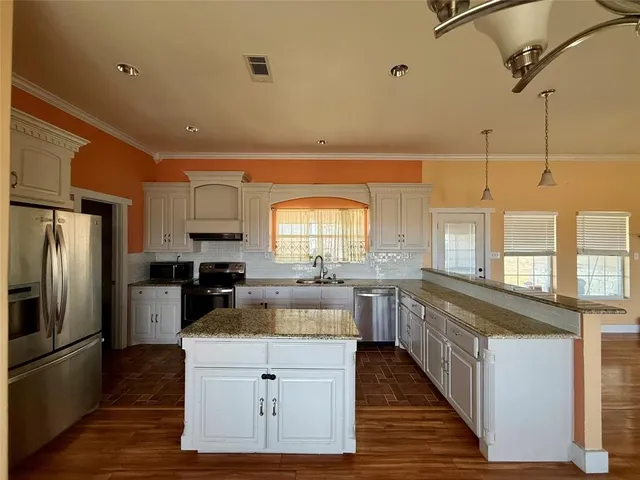 a kitchen with a refrigerator and a stove