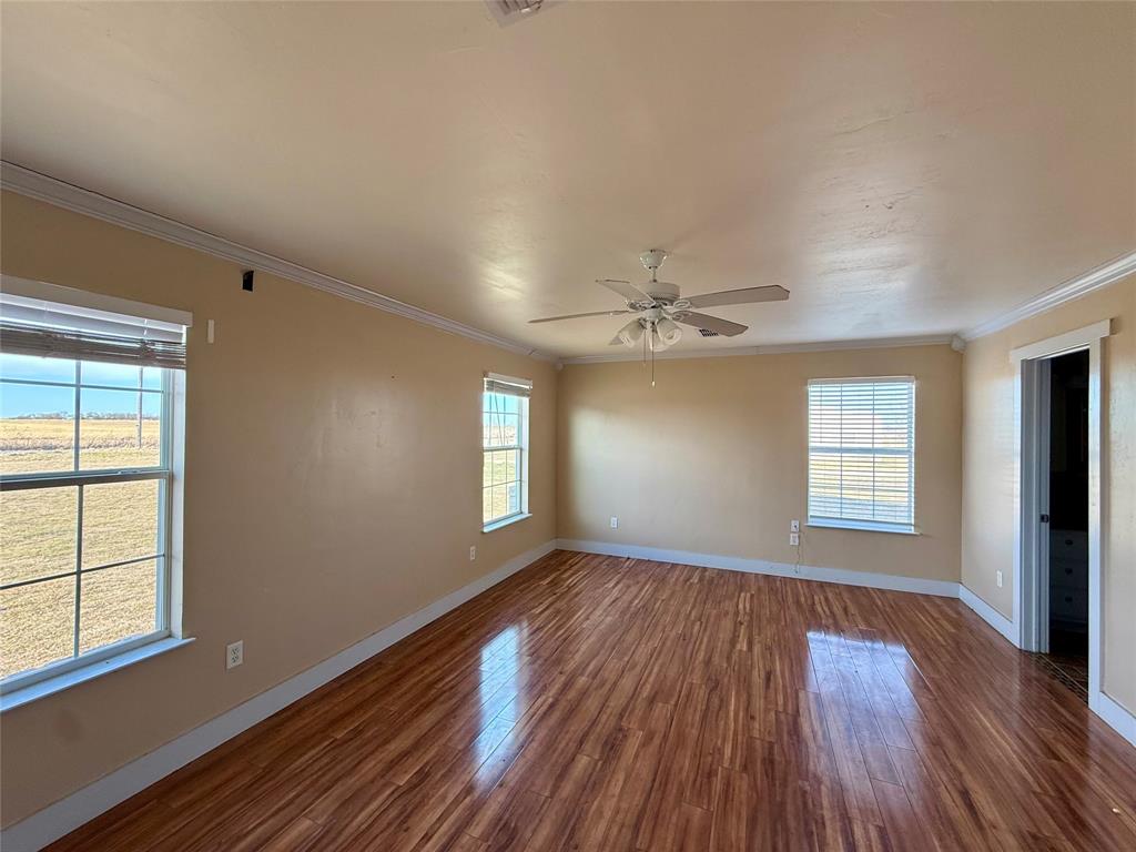 487 County Road 2622 Decatur, TX 76234 - Photo 10 of 20 an empty room with wooden floor and windows