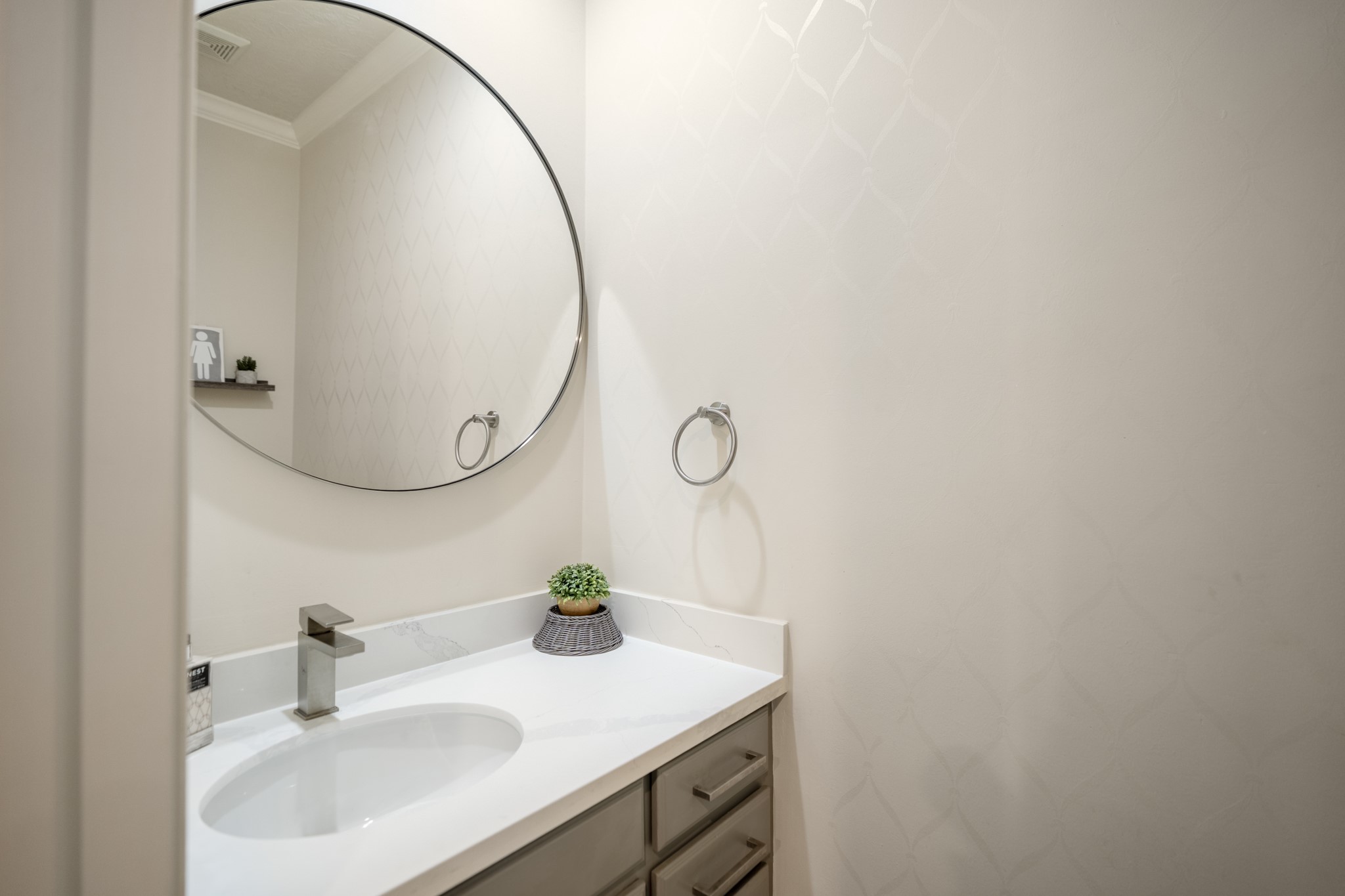 4236 Drake Street Houston, TX 77005 - Photo 14 of 43 Renovated first floor powder bathroom with premium quartz countertops and designer finishes.