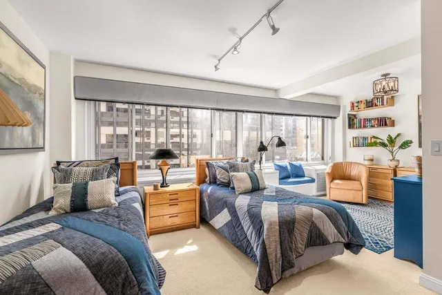 a living room with furniture a flat screen tv and a large window