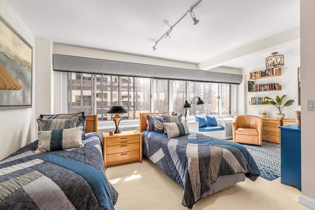 249 East 48th Street, Unit 10B Manhattan, NY 10017 - Photo 13 of 18 a living room with furniture and large windows