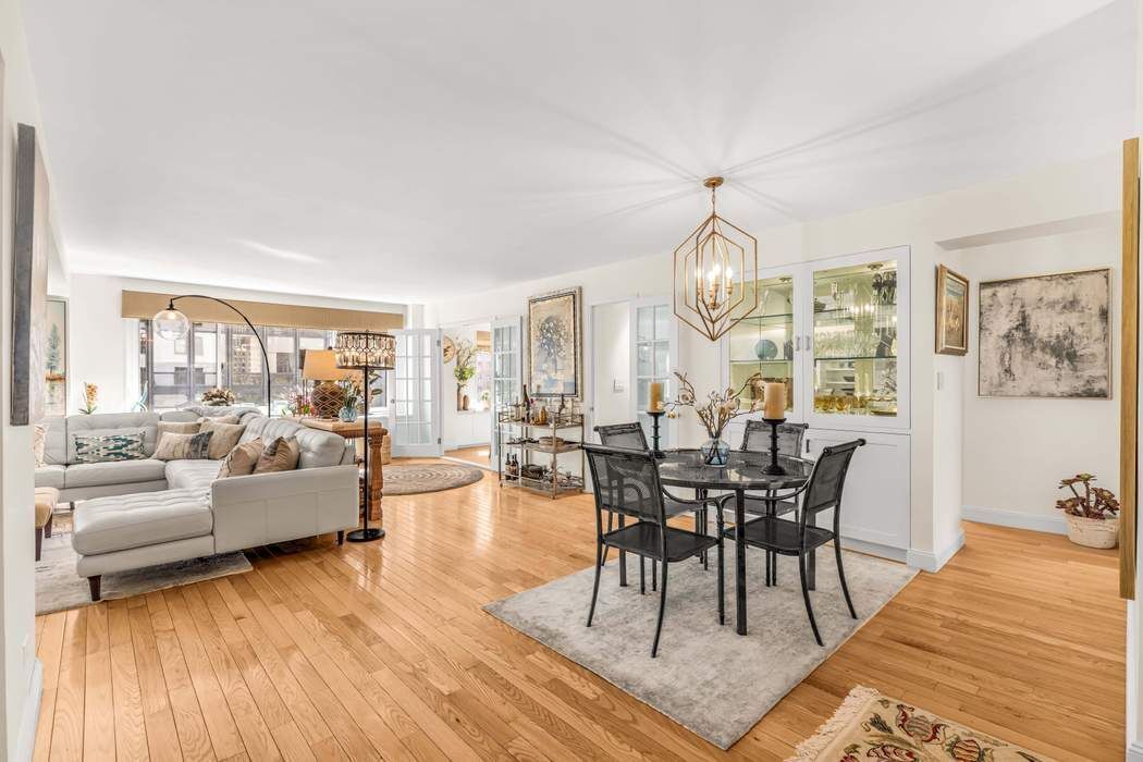 249 East 48th Street, Unit 10B Manhattan, NY 10017 - Photo 2 of 18 a view of a dining room with furniture window and wooden floor