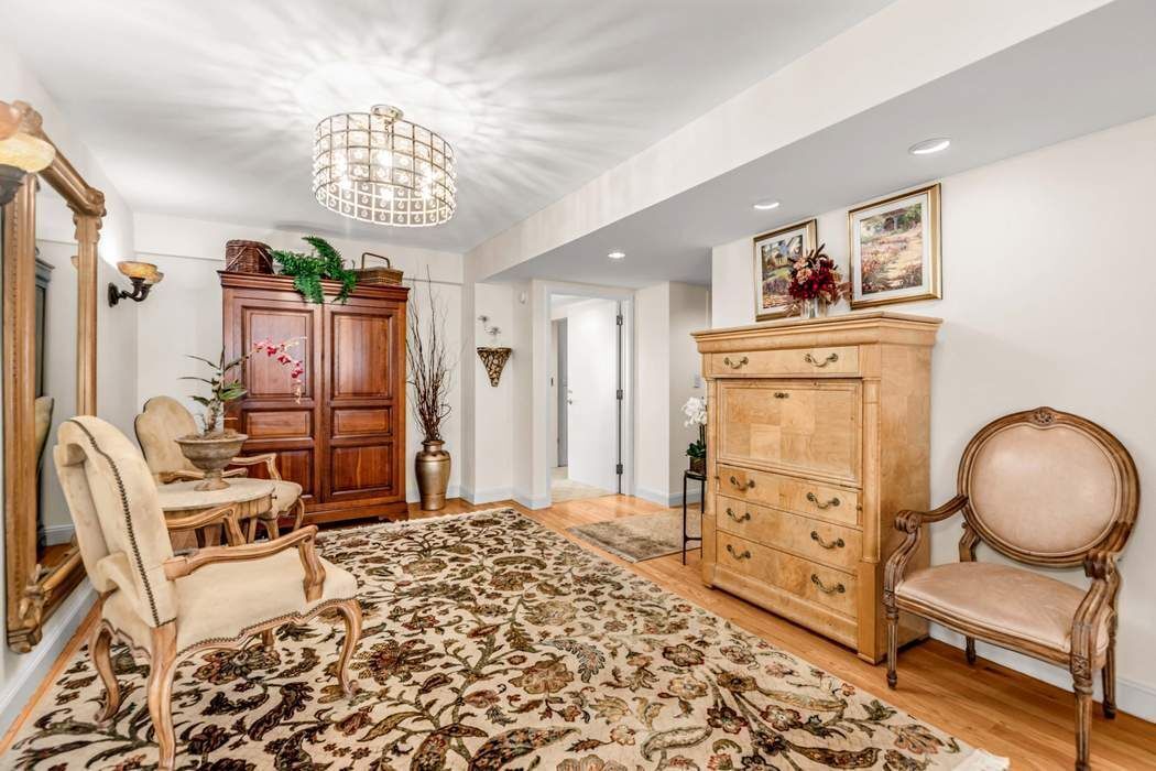 249 East 48th Street, Unit 10B Manhattan, NY 10017 - Photo 4 of 18 a bedroom with furniture and a window