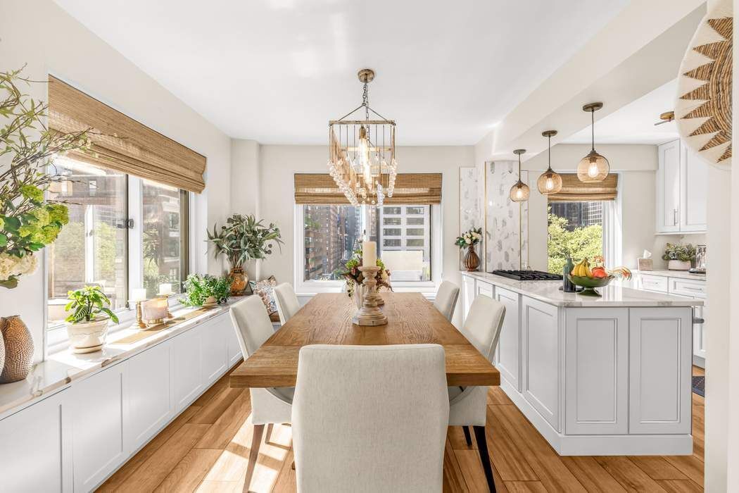 249 East 48th Street, Unit 10B Manhattan, NY 10017 - Photo 7 of 18 a view of a dining room with furniture large windows and wooden floor