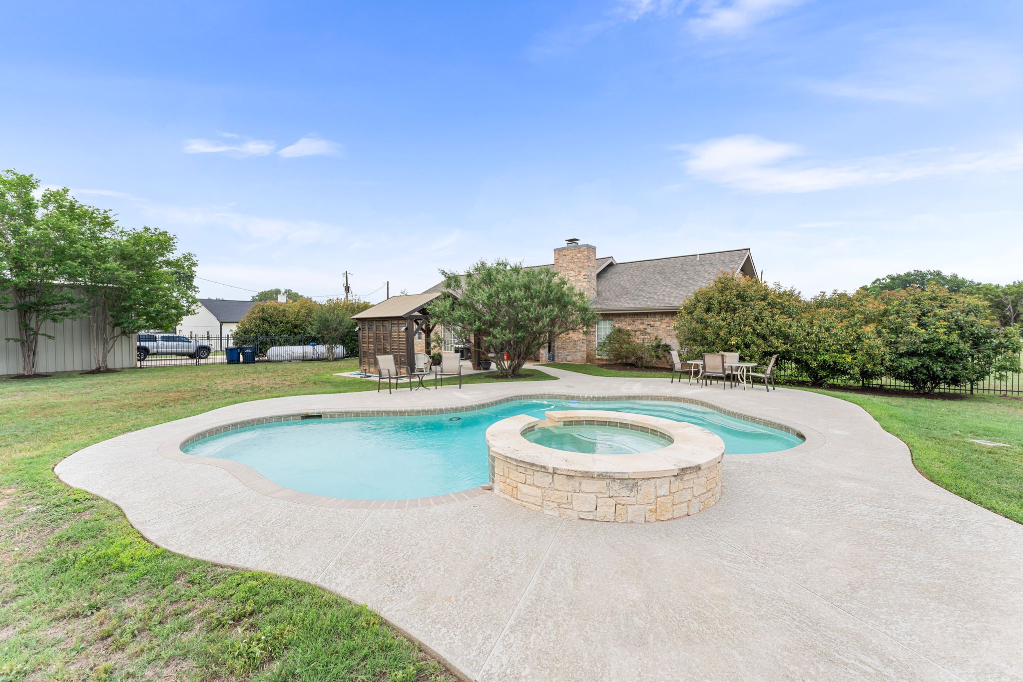 221 Breakaway Road Cedar Park, TX 78613 - Photo 11 of 39 View of swimming pool featuring a yard, a patio, and a pool with connected hot tub