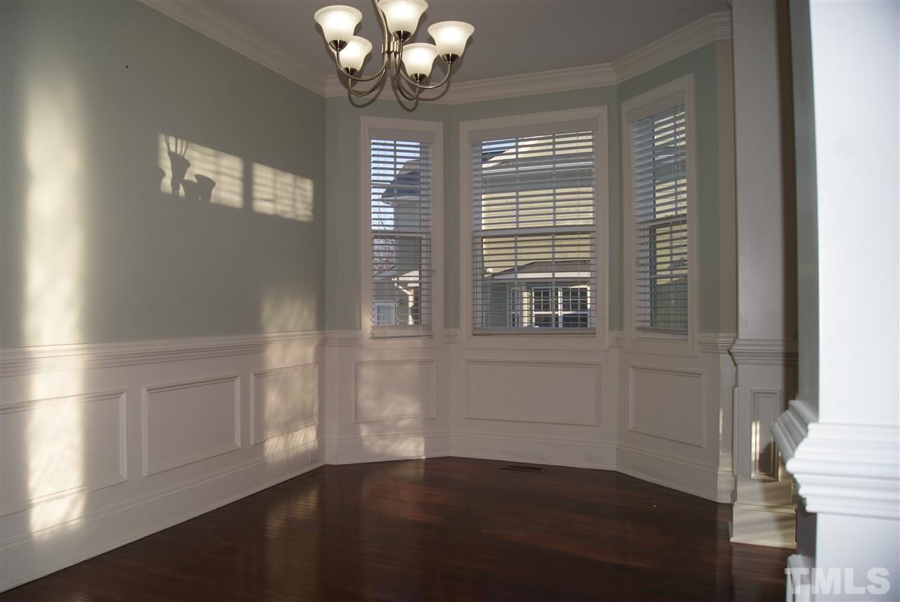 642 Democracy Street Raleigh, NC 27603 - Photo 14 of 25 a view of an empty room with wooden floor and a window