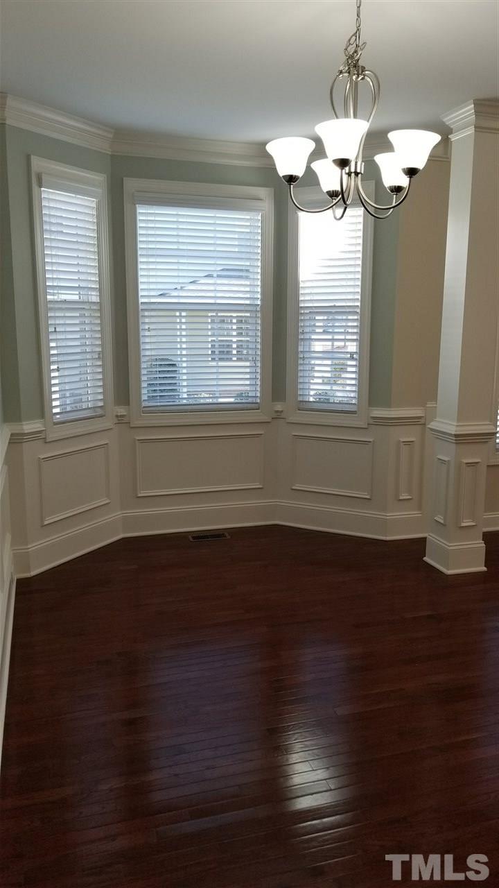 642 Democracy Street Raleigh, NC 27603 - Photo 24 of 25 a view of empty room with wooden floor and fan