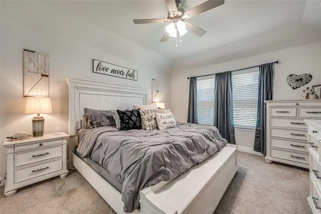 a kitchen with kitchen island granite countertop a wooden floor and a refrigerator