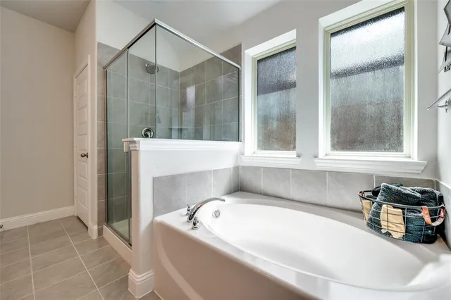 a large bathroom with a double vanity sink a mirror and a shower