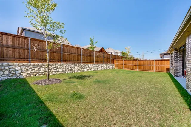 a view of a patio with table and chairs with wooden floor and fence
