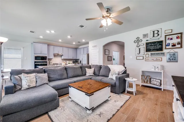 a living room with furniture and wooden floor