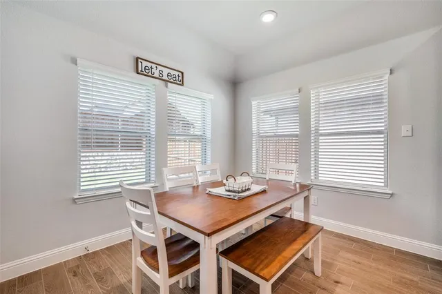 a dining room with furniture and window