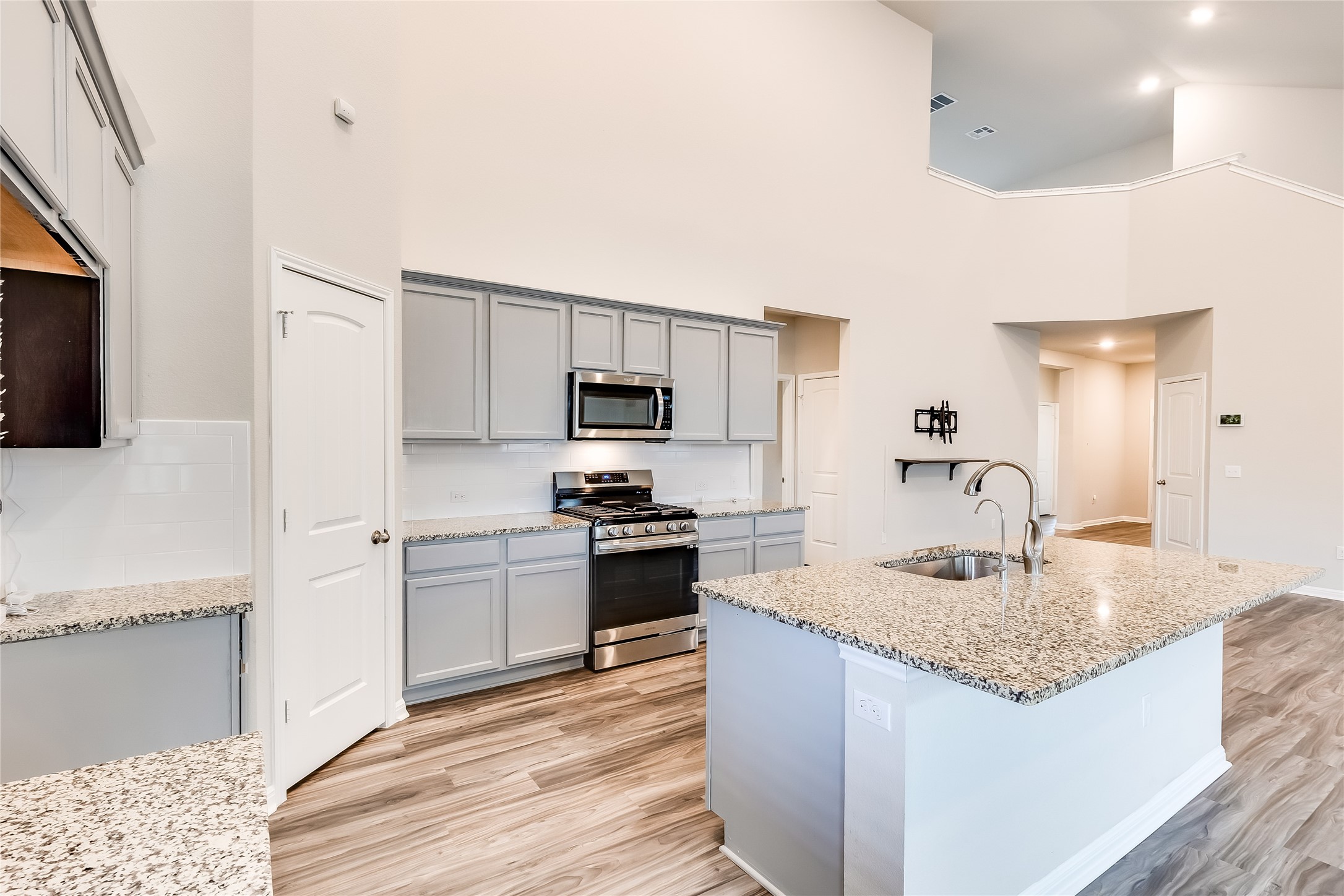 312 Empress Tree Drive Leander, TX 78641 - Photo 12 of 35 a kitchen with stainless steel appliances granite countertop a sink dishwasher stove top oven and refrigerator