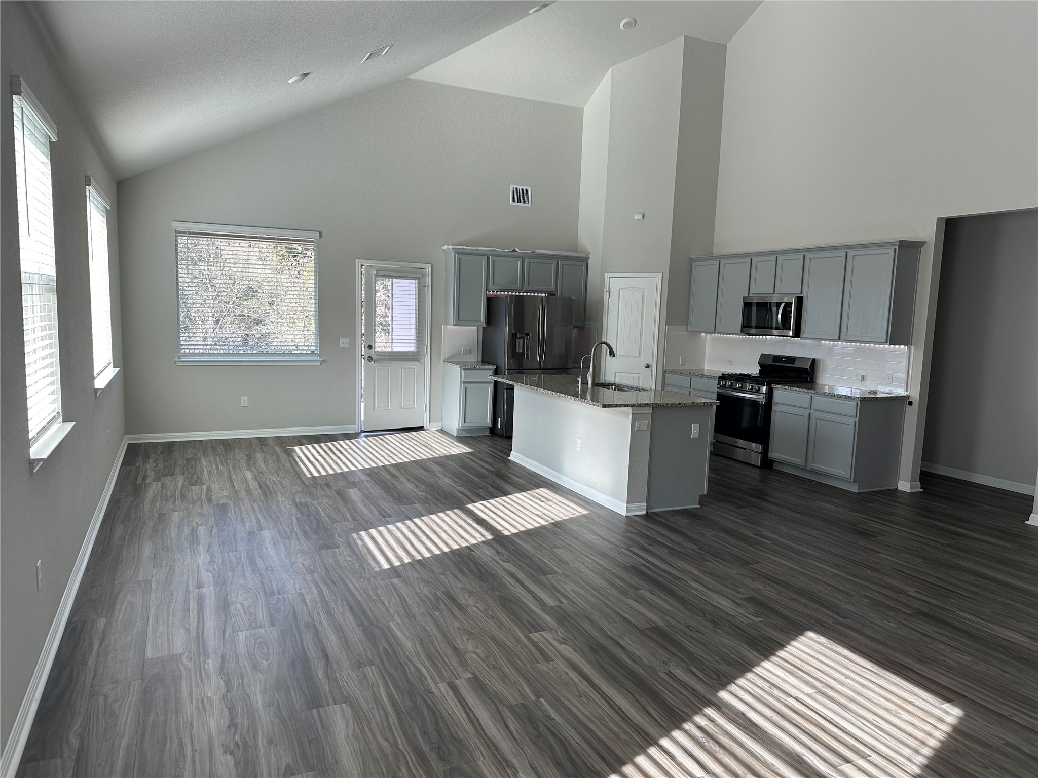 312 Empress Tree Drive Leander, TX 78641 - Photo 35 of 35 a living room with stainless steel appliances furniture wooden floor and a kitchen view