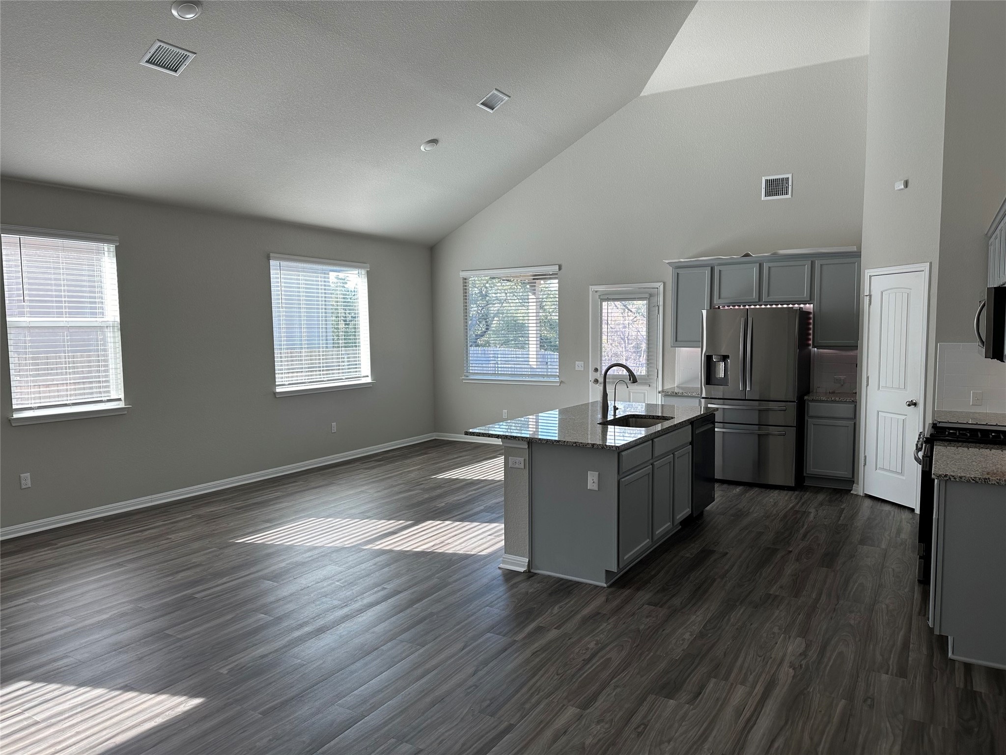 312 Empress Tree Drive Leander, TX 78641 - Photo 28 of 35 a kitchen with wooden floors and refrigerator