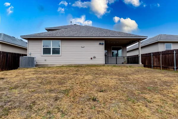 a backyard of a house with lots of green space and tree