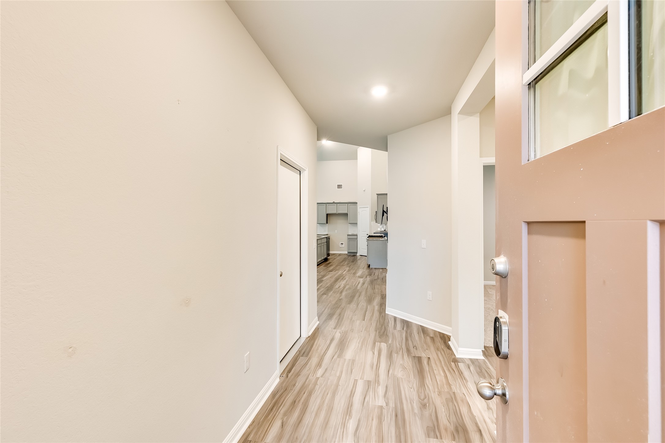 312 Empress Tree Drive Leander, TX 78641 - Photo 4 of 35 a view of a hallway with wooden floor and staircase