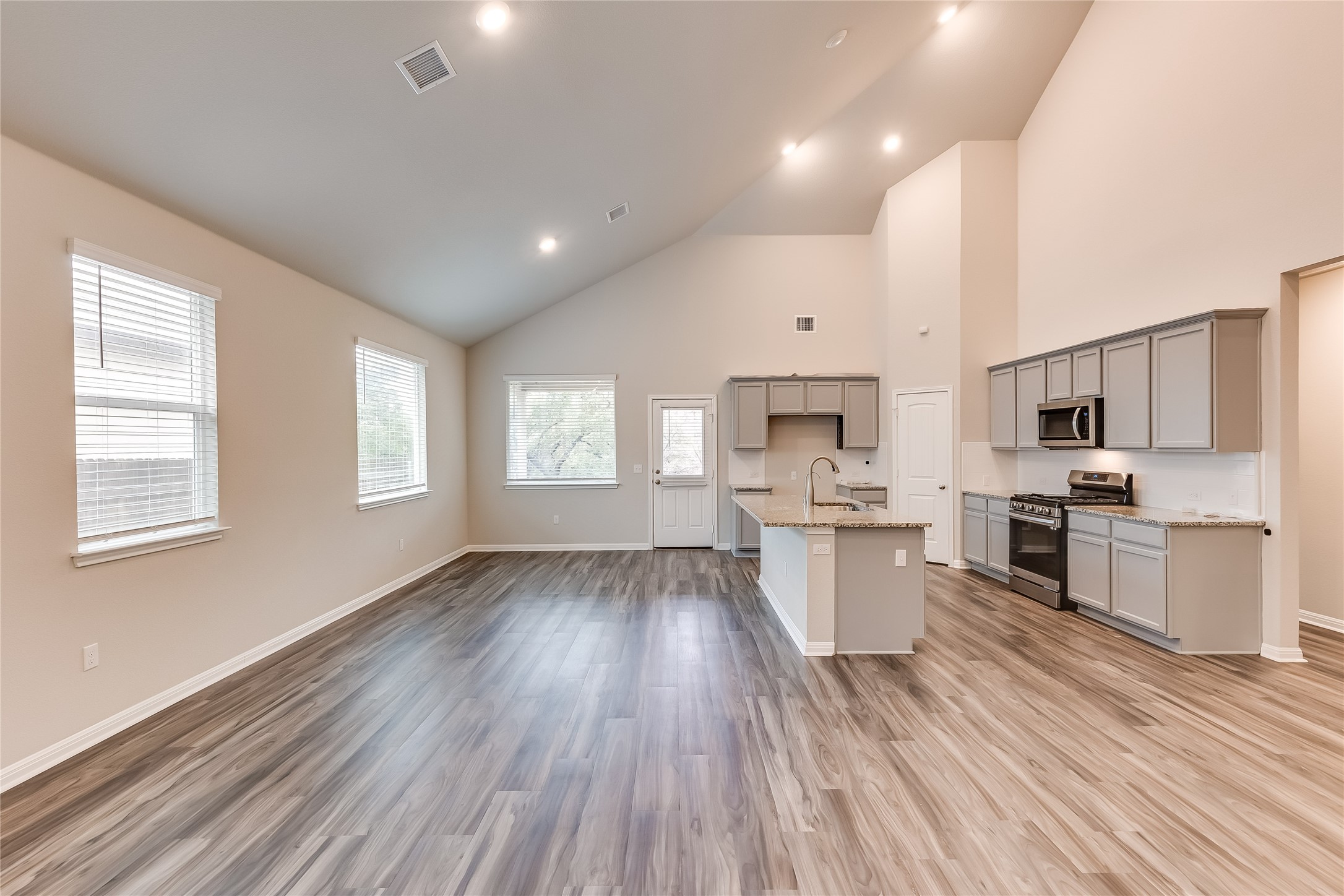 312 Empress Tree Drive Leander, TX 78641 - Photo 6 of 35 a large kitchen with a large window and stainless steel appliances
