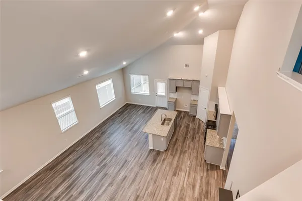a view of kitchen with granite countertop cabinets and refrigerator