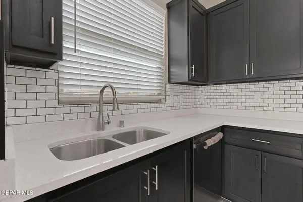 a kitchen with a sink and cabinets