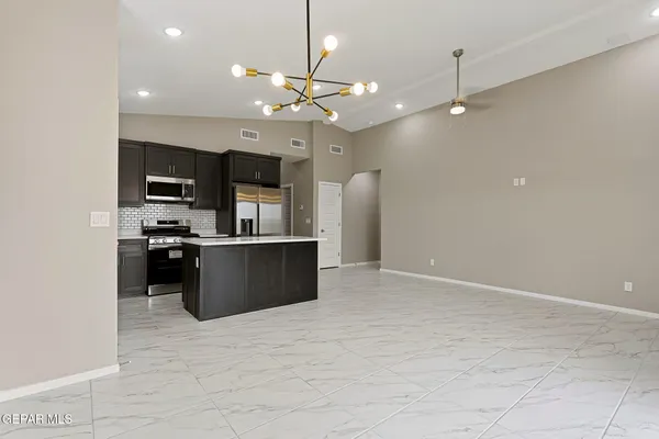 a view of kitchen with refrigerator and microwave