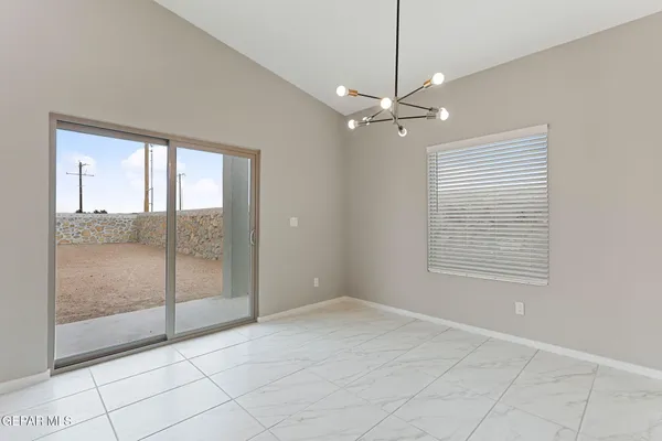 a view of an empty room with glass door