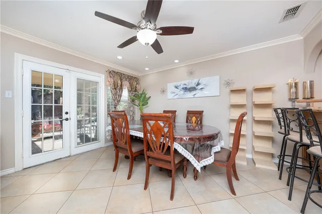 a room with a large window and cabinets
