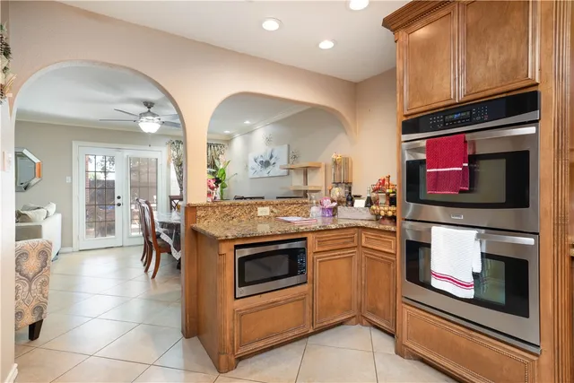 a dining room with wooden floor a chandelier a wooden table and chairs