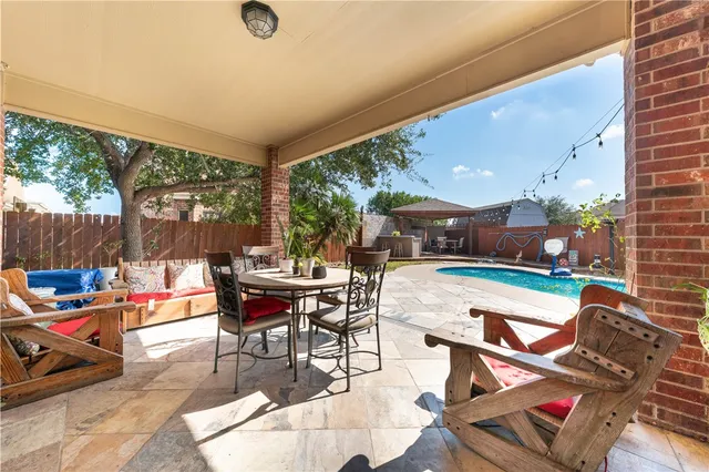 a patio with patio couch and dining table