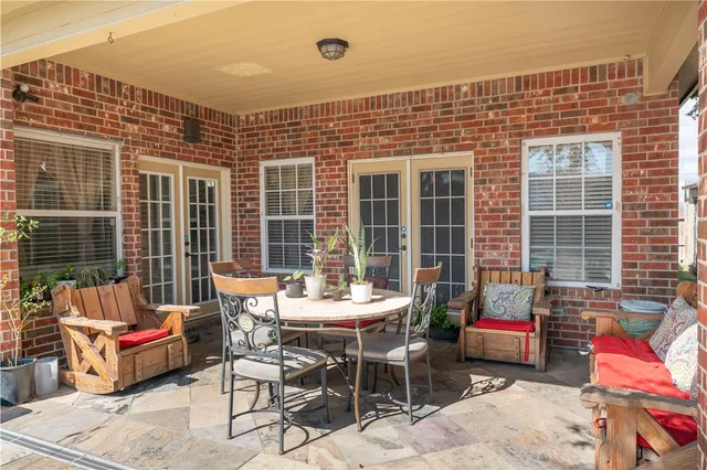 a view of balcony with chairs and wooden fence