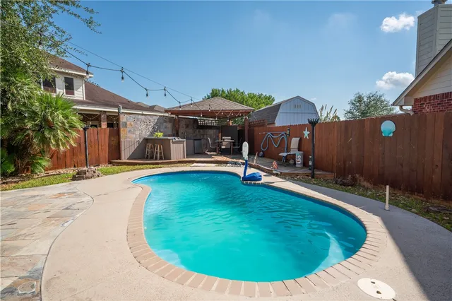 an outdoor space with swimming pool and furniture
